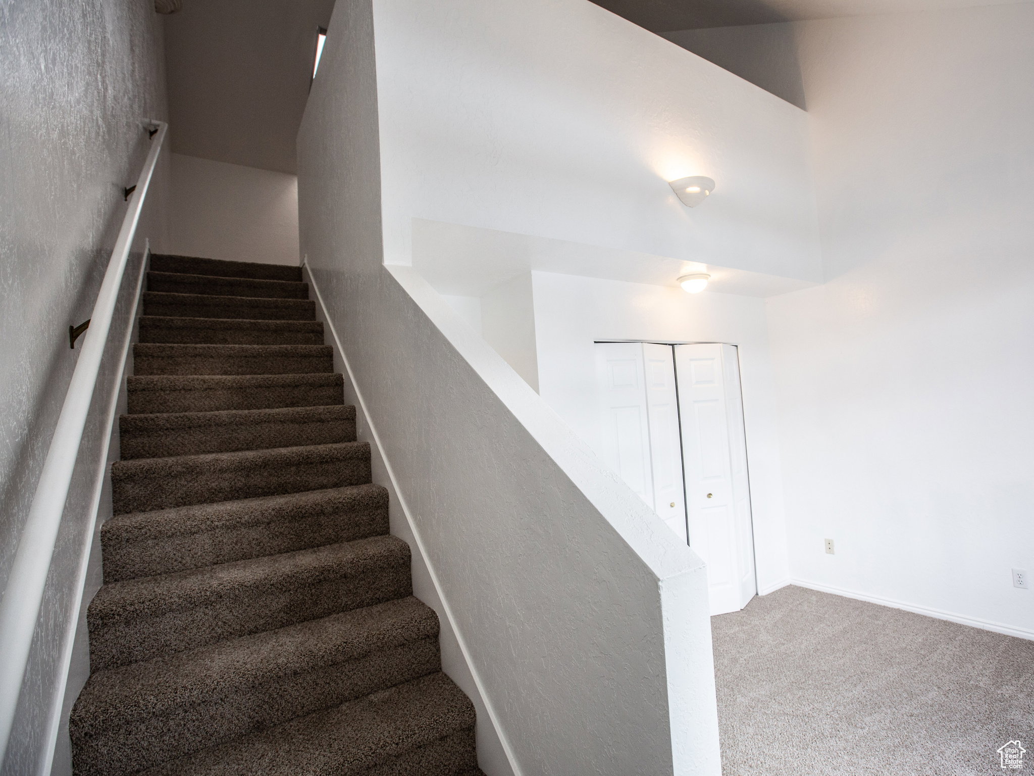 Staircase with carpet flooring and baseboards