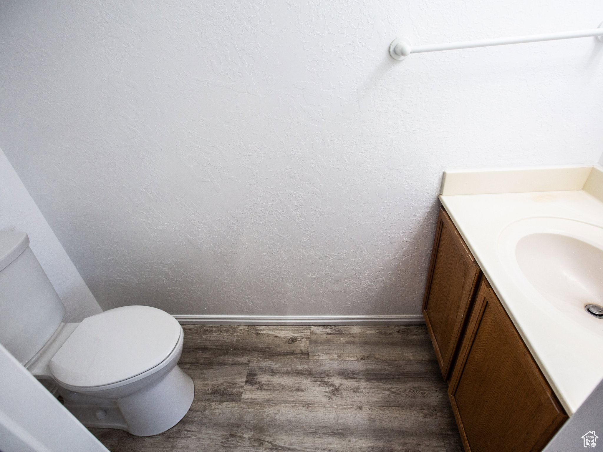 Bathroom featuring vanity and dark wood-type flooring