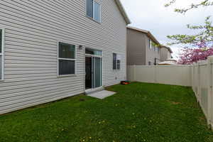 Rear view of property with a fenced backyard