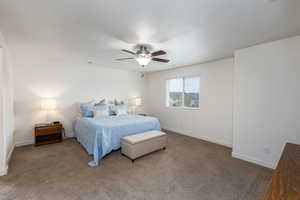 Bedroom featuring ceiling fan and carpet floors