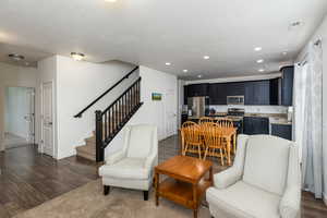 Living room with dark wood-style flooring and recessed lighting
