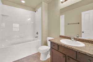 Full bathroom featuring vanity, shower / washtub combination, recessed lighting, and light tile patterned floors