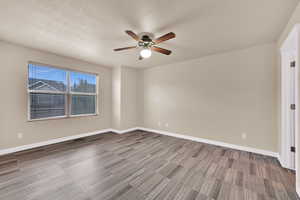 Unfurnished room with ceiling fan and a textured ceiling