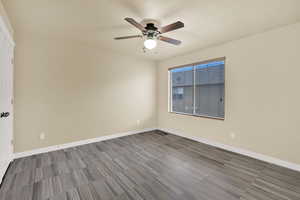 Spare room featuring baseboards and a ceiling fan