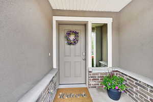 Doorway to property with stucco siding