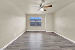 Spare room with ceiling fan and baseboards