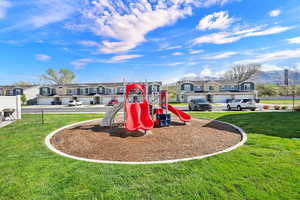Community play area featuring a residential view and a lawn