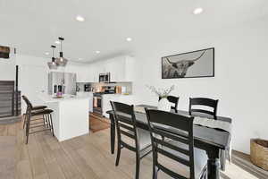 Dining space featuring wood finish floors and recessed lighting