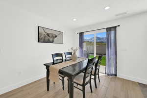 Dining room featuring light wood-type flooring and recessed lighting