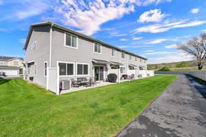 Rear view of house with stucco siding and a patio