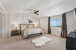 Bedroom featuring light colored carpet, vaulted ceiling, a ceiling fan, and recessed lighting