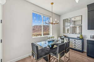 Dining space with light wood-style floors and a chandelier