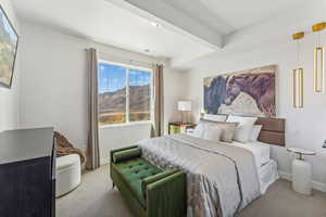 Carpeted bedroom featuring a mountain view and baseboards