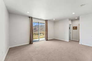 family room featuring a mountain view, light carpet, and recessed lighting