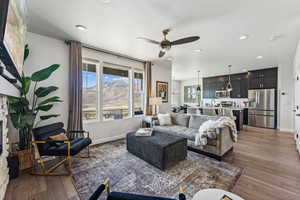 Living area featuring ceiling fan, dark wood-style floors, and recessed lighting