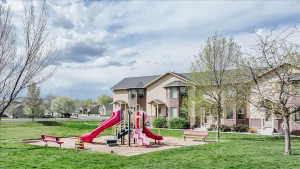 Community play area featuring a lawn and a residential view