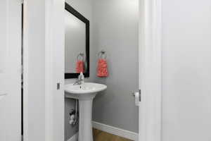 Bathroom featuring baseboards and light wood-style floors