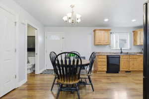 Dining space with a chandelier and light wood finished floors