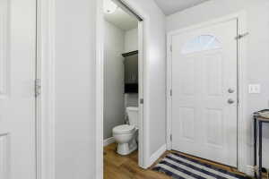 Foyer with light wood-type flooring and baseboards