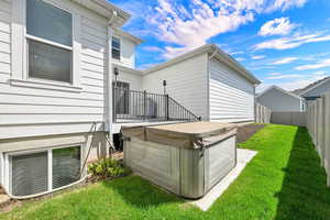 Rear view of house with a hot tub