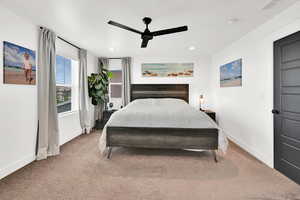 Carpeted bedroom with ceiling fan and recessed lighting