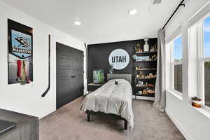 Bedroom with carpet and a closet