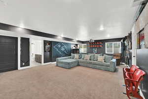 Living area with light colored carpet and baseboards