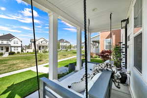 Sunroom / solarium featuring covered porch and a residential view