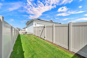 Fenced backyard featuring a gate