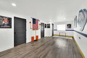 Spare room featuring dark wood-style floors and recessed lighting