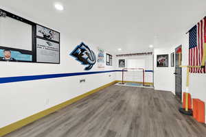 Workout room featuring wood finished floors and recessed lighting