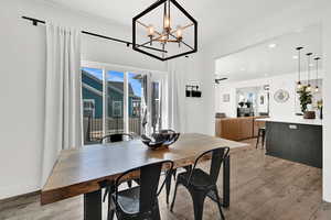 Dining room featuring light wood-style floors and hanging lights