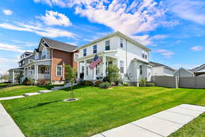 Traditional home featuring covered porch