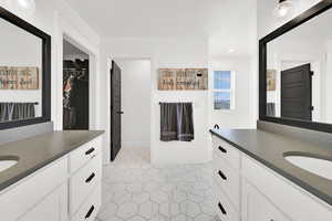 Full bathroom featuring two vanities