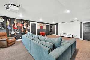 Living room with carpet flooring and a textured ceiling