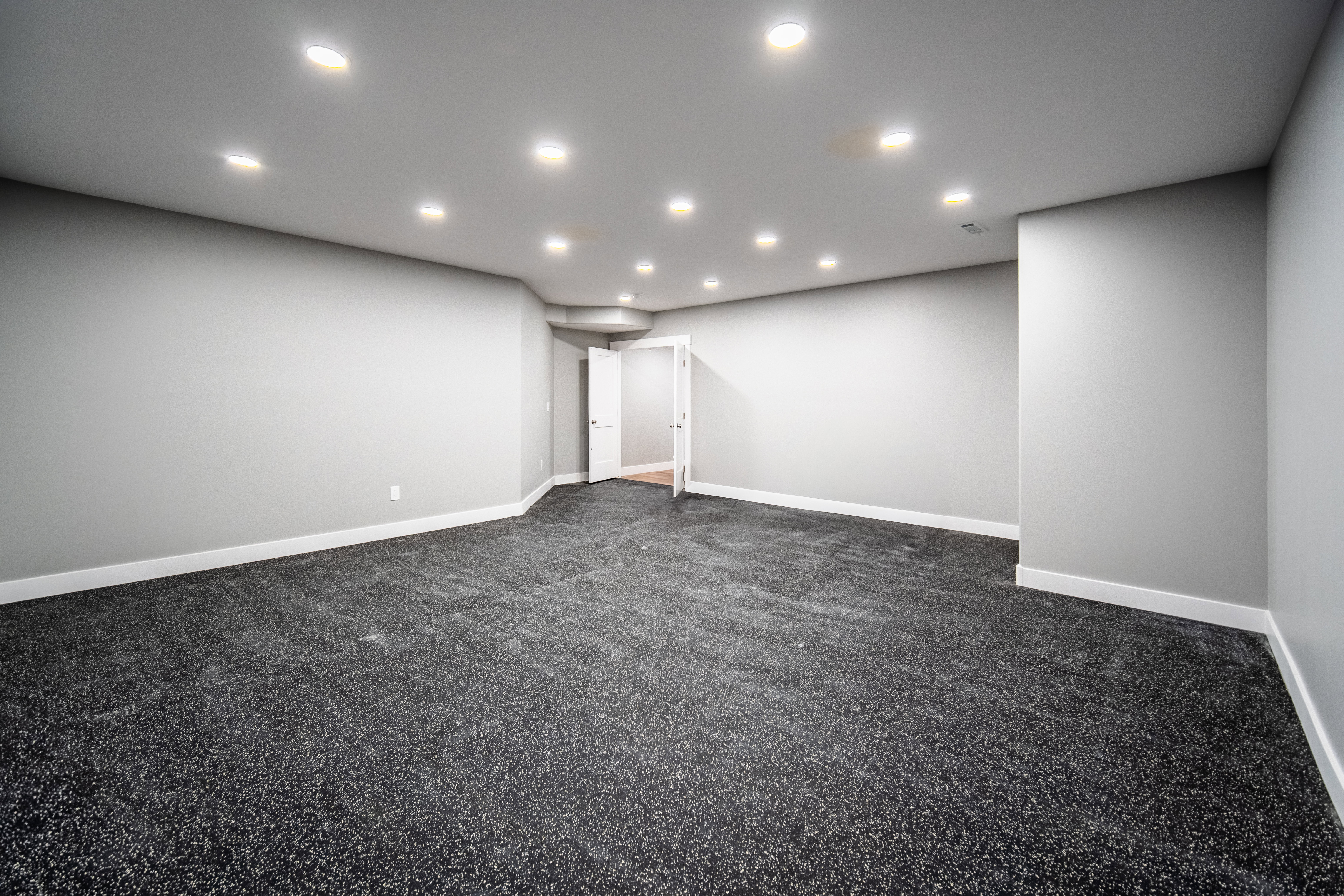 Home gym featuring Interlocking EVA foam flooring and space for equipment and racks.