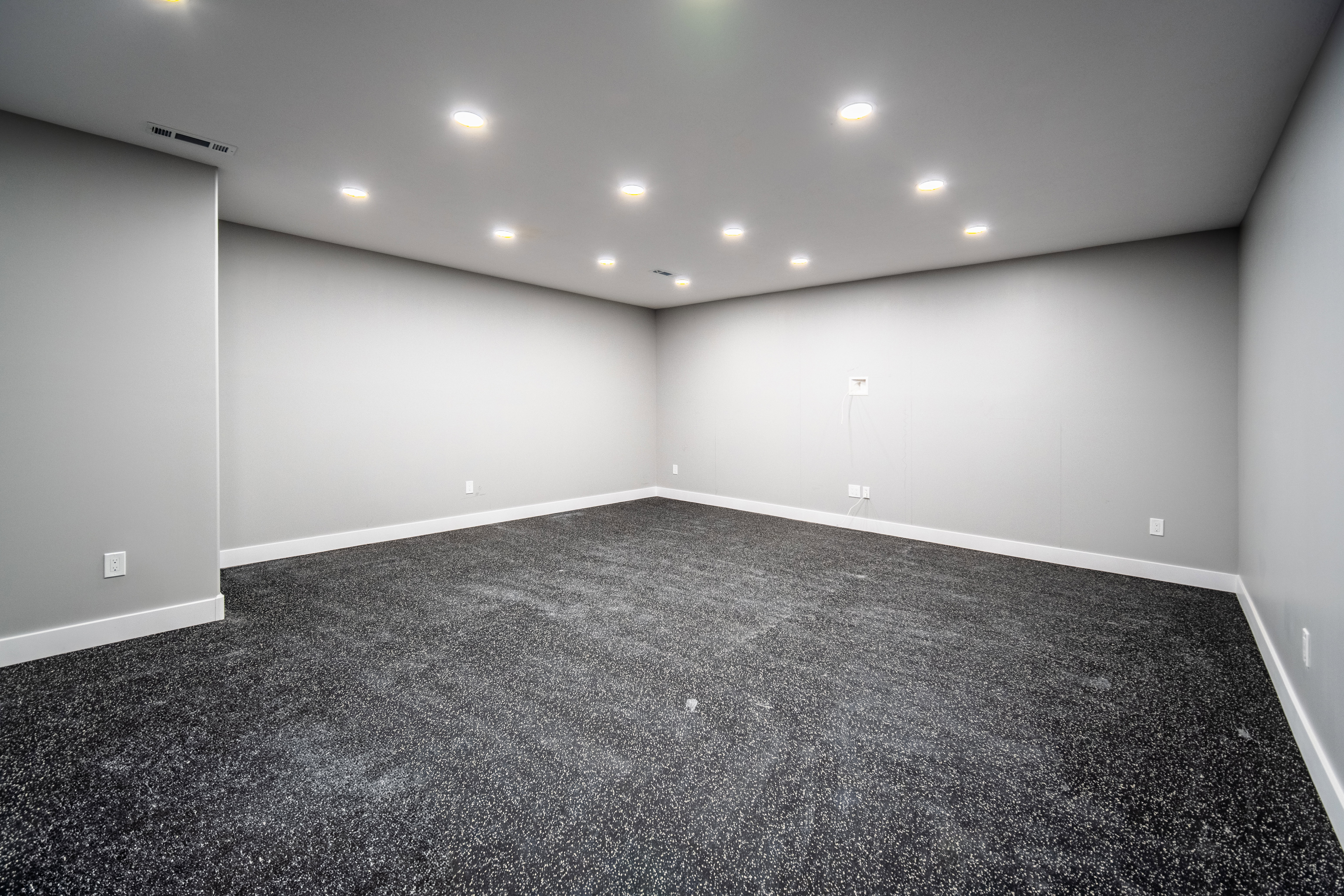 Home gym featuring Interlocking EVA foam flooring, space for equipment and racks, and designated TV location