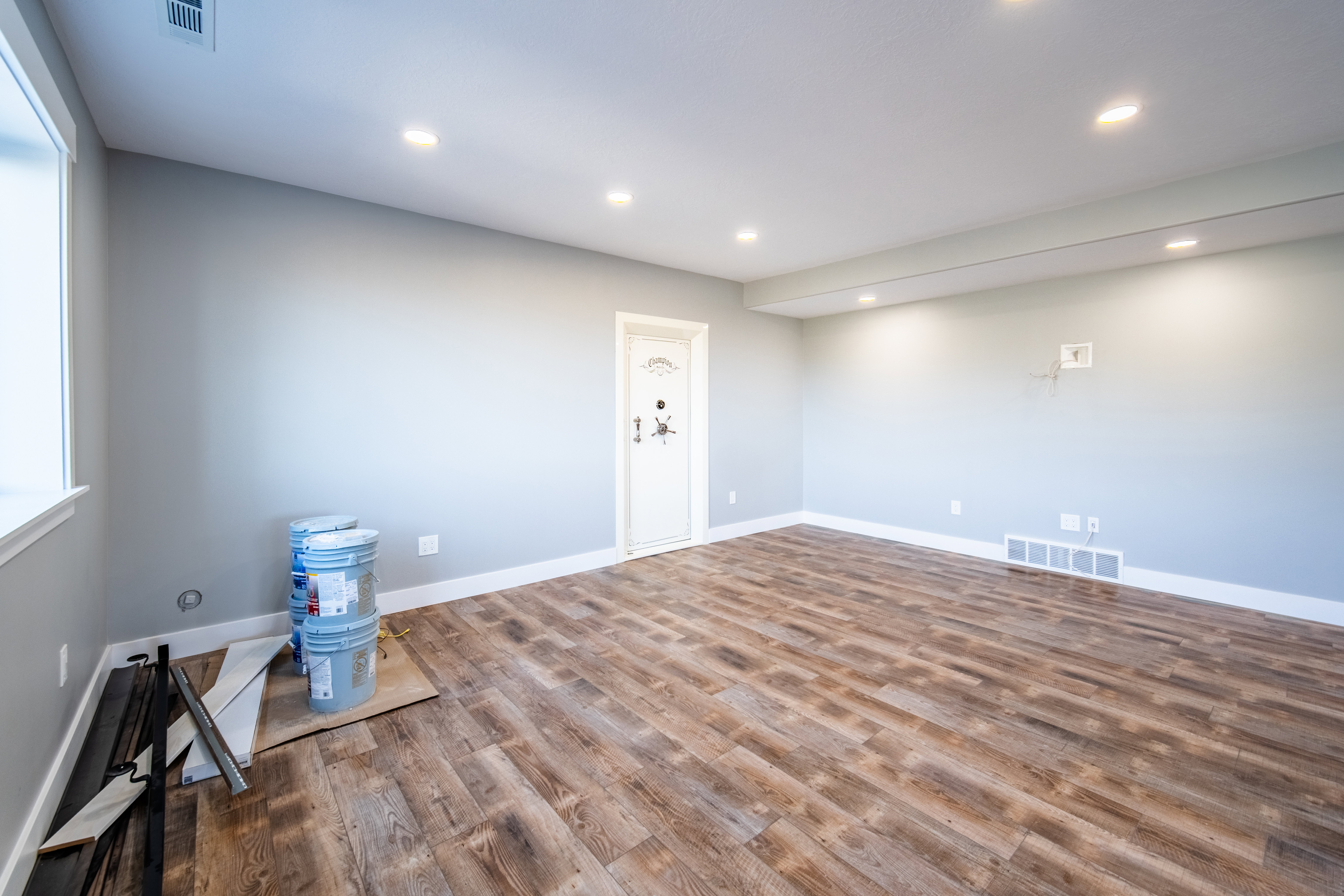 Basement living room with wood-style floors and recessed lighting