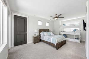 Bedroom featuring light carpet and ceiling fan