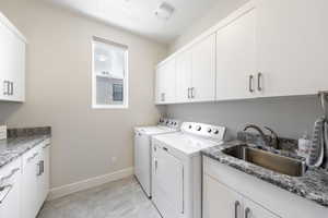 Laundry room with cabinet space and separate washer and dryer