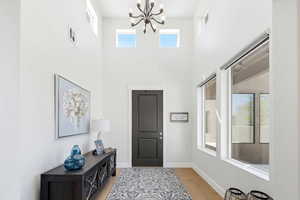 Entryway with hanging lights and light wood-type flooring