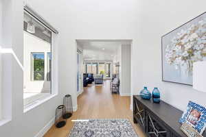 Hall featuring light wood-style floors and baseboards
