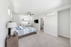 Bedroom featuring ceiling fan, light colored carpet, and connected bathroom