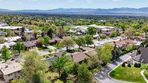 Aerial perspective of suburban area with a mountainous background