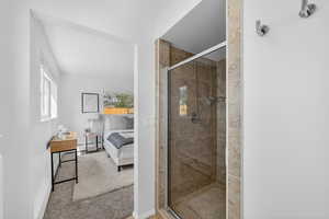 Full bathroom with connected bathroom, a stall shower, and light carpet