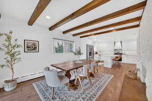 Dining area with recessed lighting, light wood finished floors, beam ceiling, and a baseboard radiator