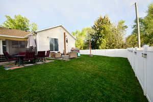 Rear view of house with a patio and a fenced backyard