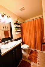 Bathroom featuring vanity, a shower with curtain, and light tile patterned floors