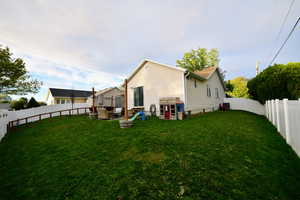 Rear view of property with a fenced backyard
