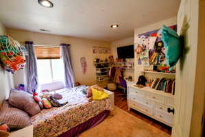 Bedroom with dark wood finished floors and recessed lighting